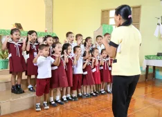 : The children sing and play with enthusiasm.